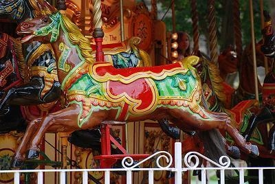 When a carousel is in motion, the movement of the carousel horse can BEST be described-example-1