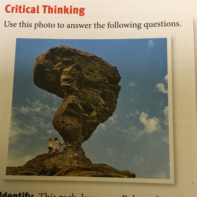 This rock known as balanced rock sits on a thin spike of rock in a canyon in Idaho-example-1