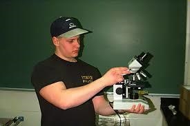 Why do you place one hand under the base of the microscope as you carry it?-example-1