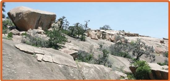 The photo shows plates of rock breaking away from a large mass of rock. Which form-example-1