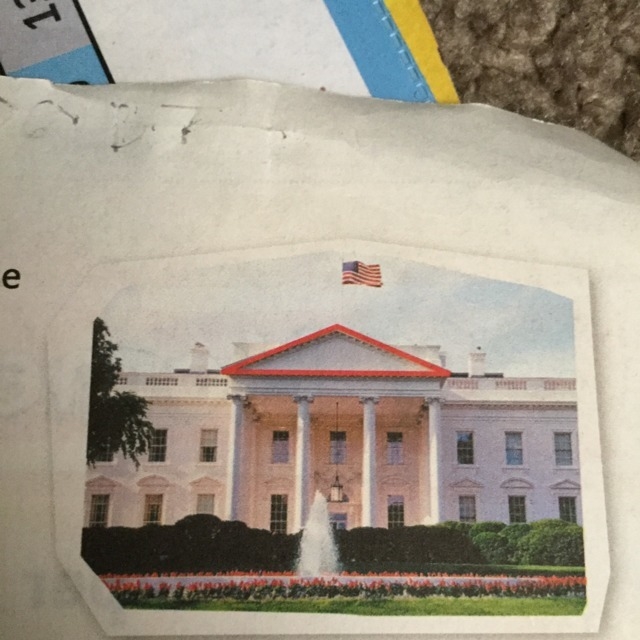 Look at the triangle on the top of the White House in the photo. Describe the size-example-1