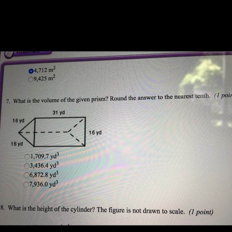 What is the volume of the given prism? round the answer to the nearest tenth. please-example-1