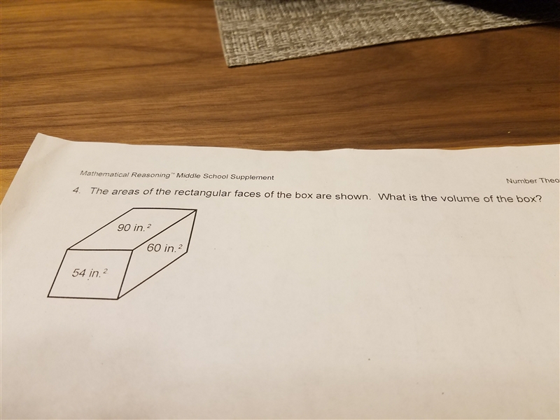 The area of the rectangular faces of the box are shown . What is the volume of the-example-1