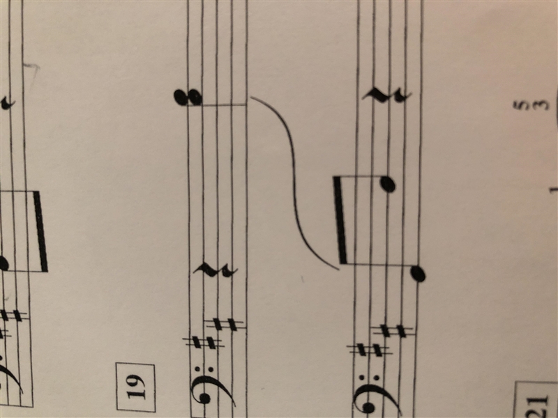 What does the curved line mean? (music)-example-1