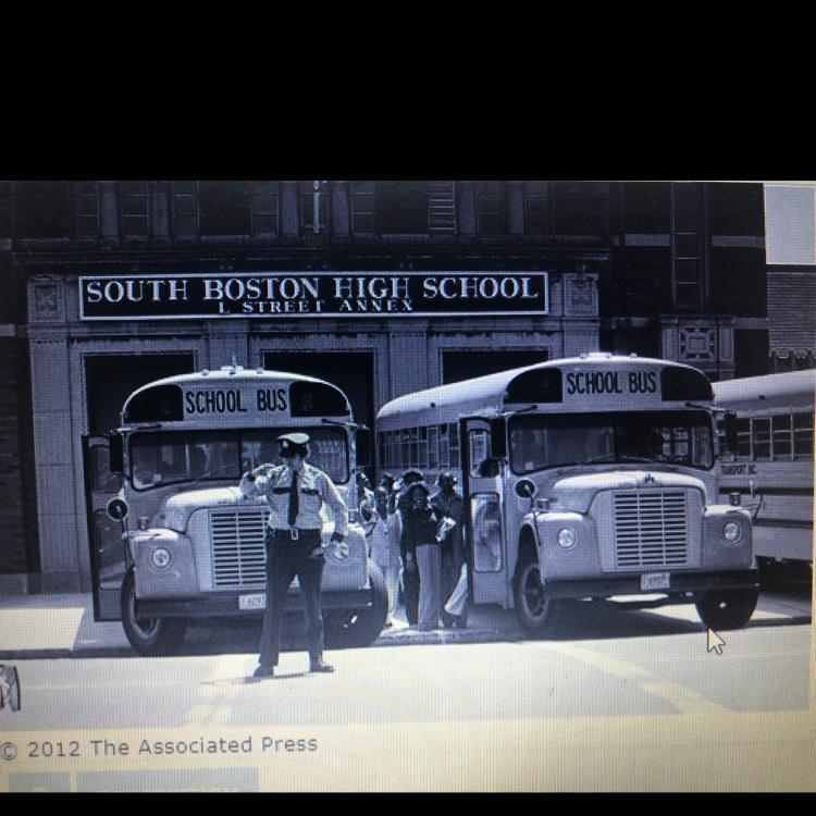 Exam the photo below and read the caption as it is appeared in a 1975 newspaper: Caption-example-1