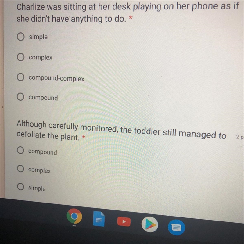 Charlize was sitting at her desk playing on her phone as if she didn't have anything-example-1