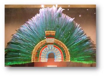 What is this headdress made from? a. eagle feathers b. quetzal bird feathers c. ostrich-example-1