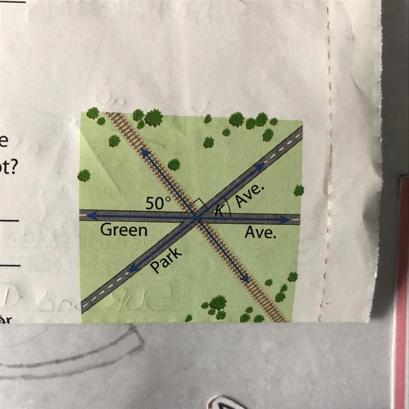 The railroad tracks meet the road as shown. The town will allow a parking lot at angle-example-1