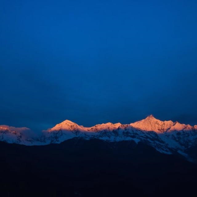 During sunset, why do mountaintops still get sunlight after the sun isn't visible-example-1