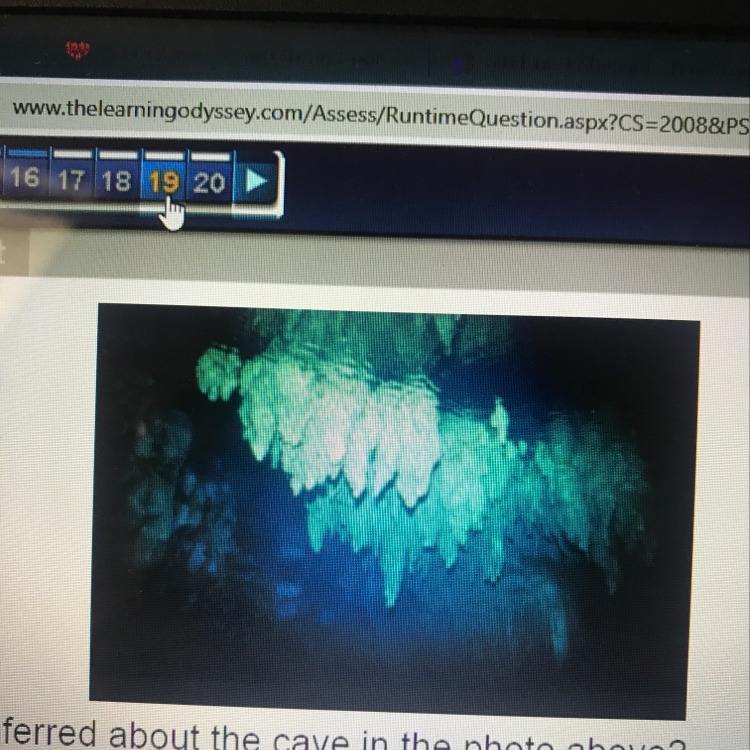 What can be inferred about the cave in the photo above? A. It is located in a lake-example-1