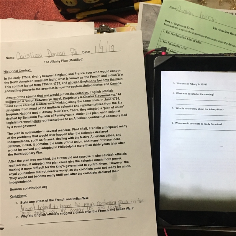 Answer the questions on the paper and the iPad using the text on the paper properly-example-1