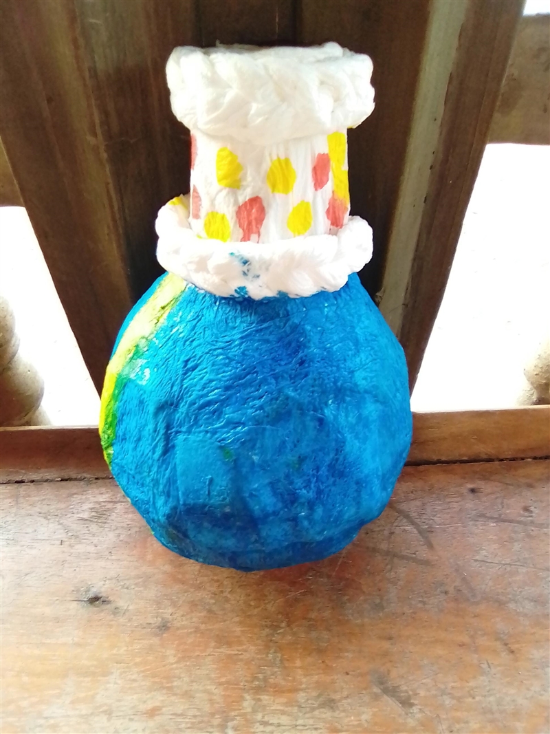 Hi. My cousin did a paper mache vase and isn't sure on the color to use for the white-example-2