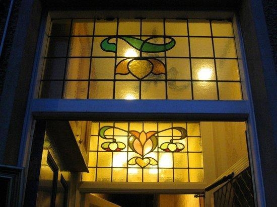 What is one example of a simple asymmetrical stained glass window? (Please add picture-example-1