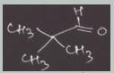 The aqueous hydroxide-promoted reaction of the compound with 2,2-dimethylpropanal-example-1