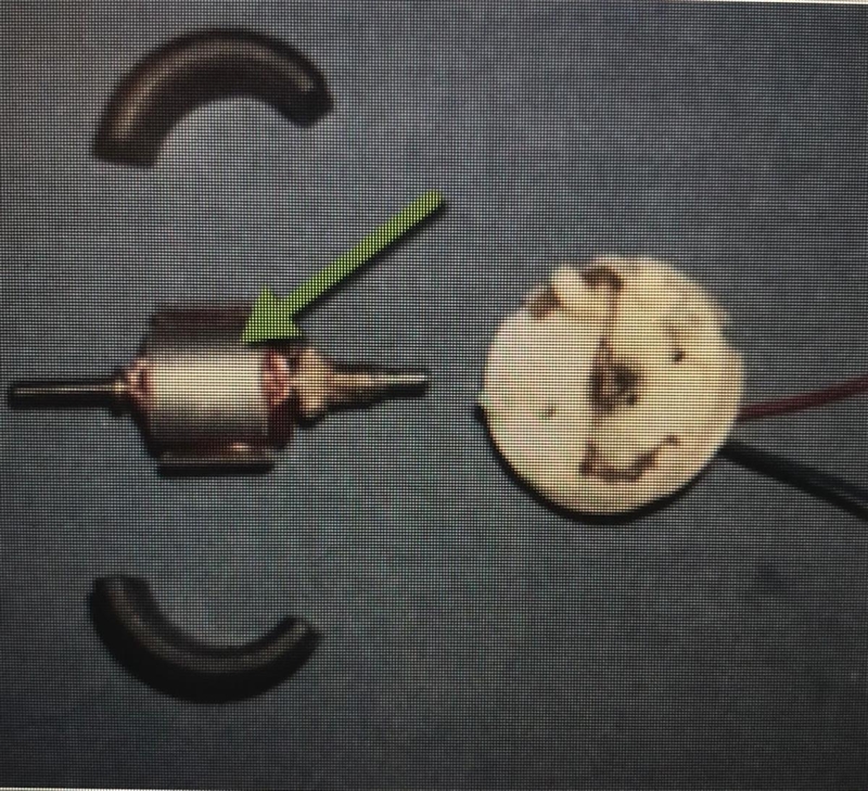 The part in the middle with a coil of wire wrapped around a metal shaft is part of-example-1