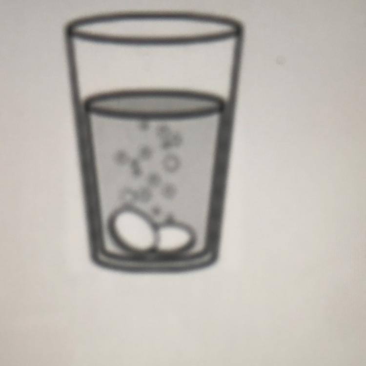 A teacher puts two tablets in a glass of water. The teacher stirs the water with a-example-1