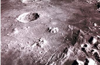 The image below shows the surface of the Moon. The circle-shaped pits on the surface-example-1