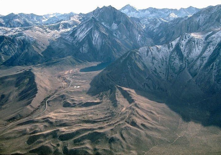 4. Name the hummocky landforms near the lower center part of the image (not the mountains-example-1