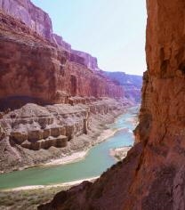 The landform in the photo below is a deep valley with high walls, often formed by-example-1