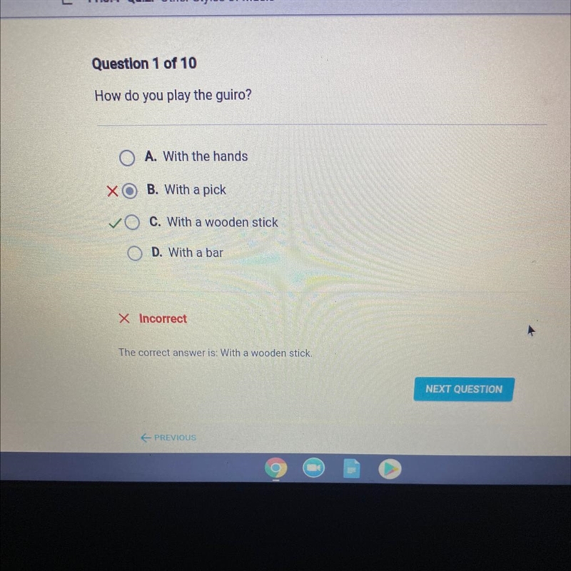 Question 1 of 10 How do you play the guiro? A. With the hands B. With a pick C. With-example-1