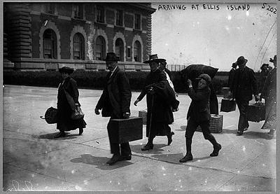 Look at the image of immigrants arriving at Ellis Island.This photograph reveals that-example-1