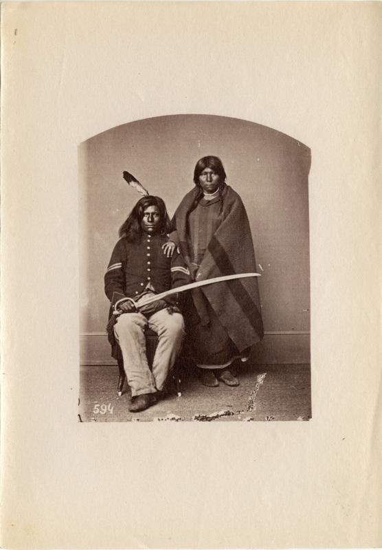 Why does the Pawnee warrior Loots-Tow-Oots hold a sword in the photograph taken of-example-1