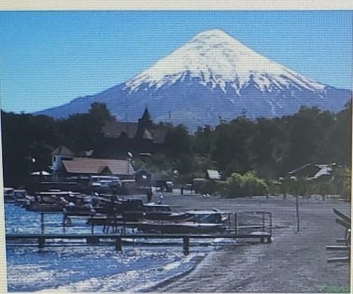 The image shows Osorno in Chile, which last erupted in 1869. Which phrase best describes-example-1