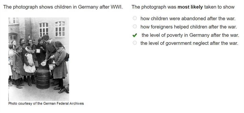 The photograph shows children in Germany after WWI. A photo of several children lining-example-1