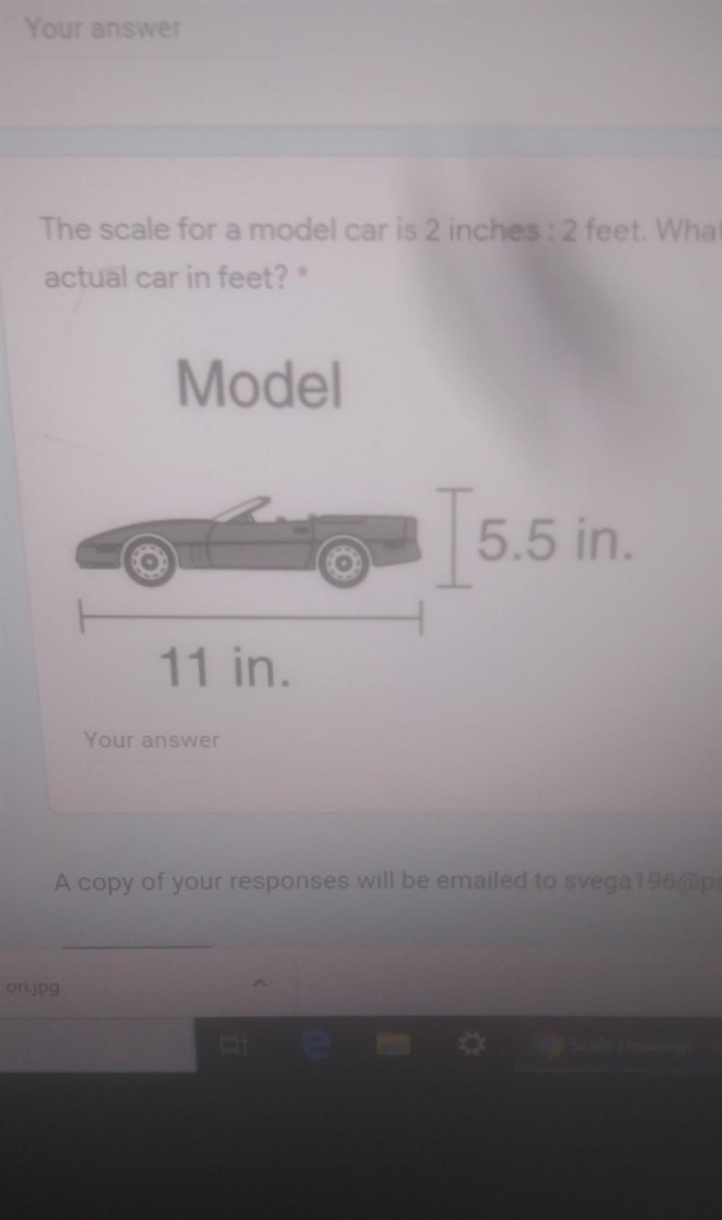 The scale for a model car is 2 inches : 2 feet. What is the height of the actual car-example-1