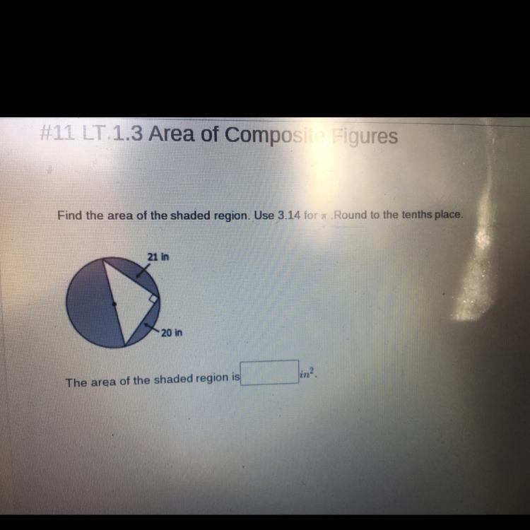 Find the area of the shaded region. Use 3.14 for Round to the tenths place. 21 in-example-1