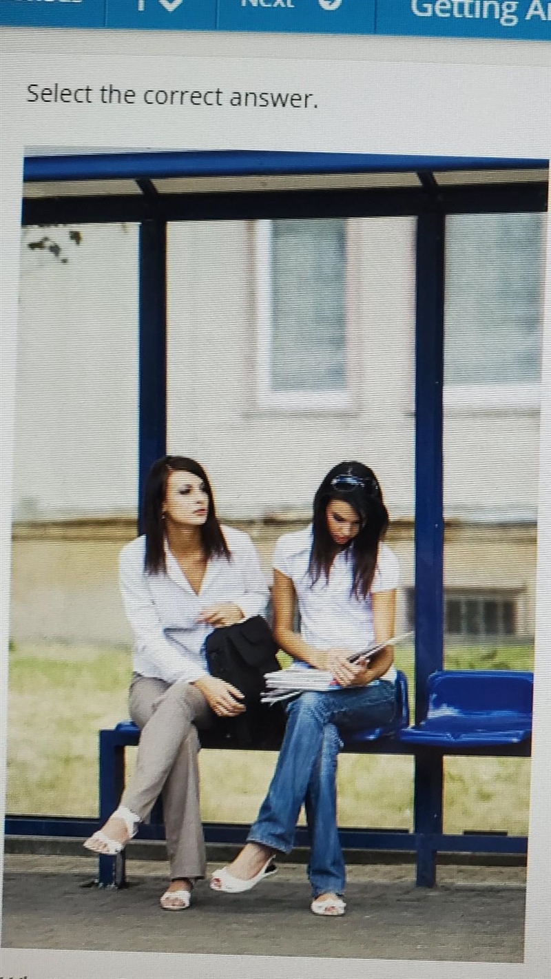 What are the women in the picture doing? ON caminando hacia la parada del bus OB, esperando-example-1