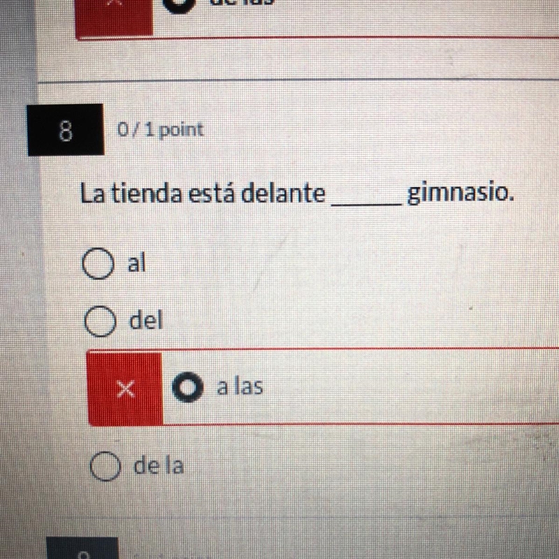 La tienda está delante _____ gimnasio.-example-1