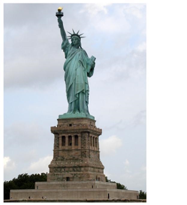 This photograph shows the Statue of Liberty. A green statue of a woman holding a book-example-1