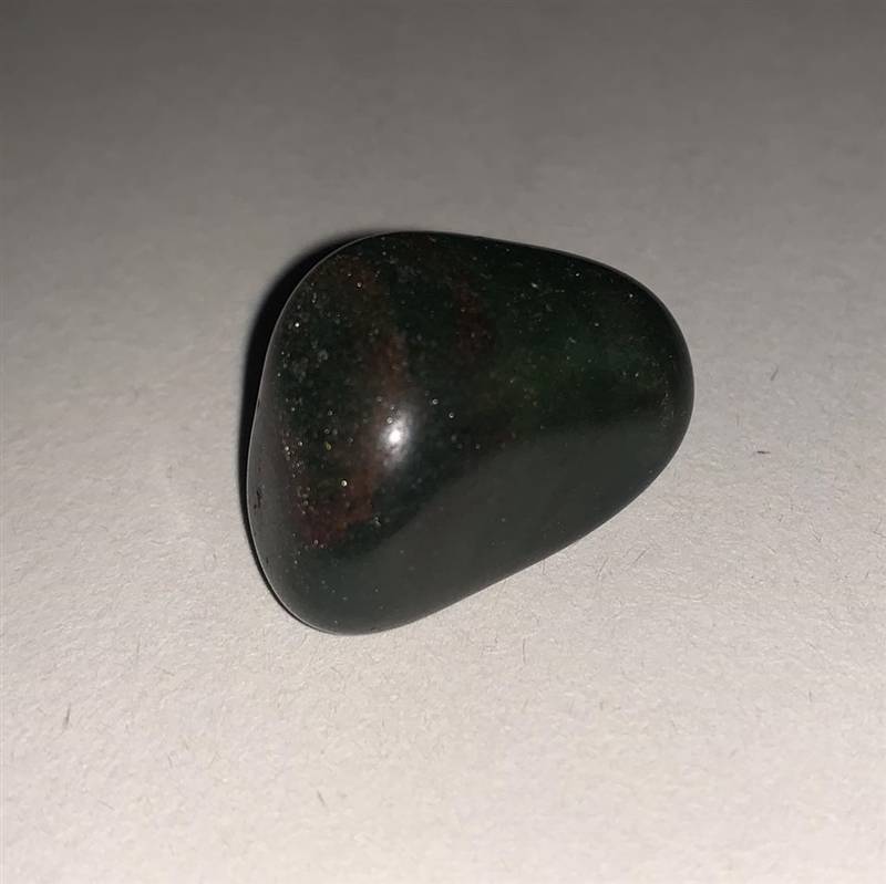 Can anyone help me identify this crystal? Plz help. It’s dark green and has like a-example-1