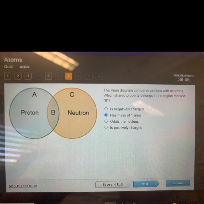 The Venn diagram compares protons with neutrons. Which shared property belongs in-example-1