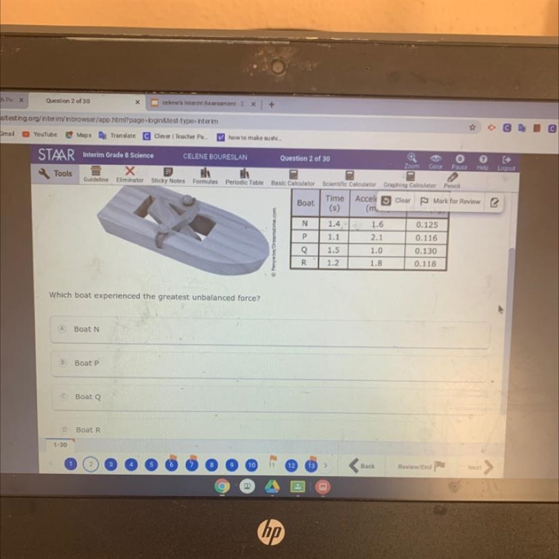 The photograph shows one of the boats in a science club's toy boat race. All the boats-example-1