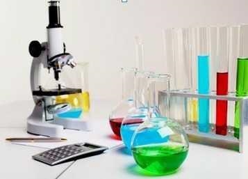 The image shows various objects. A microscope, calculator, pen, beakers with liquid-example-1