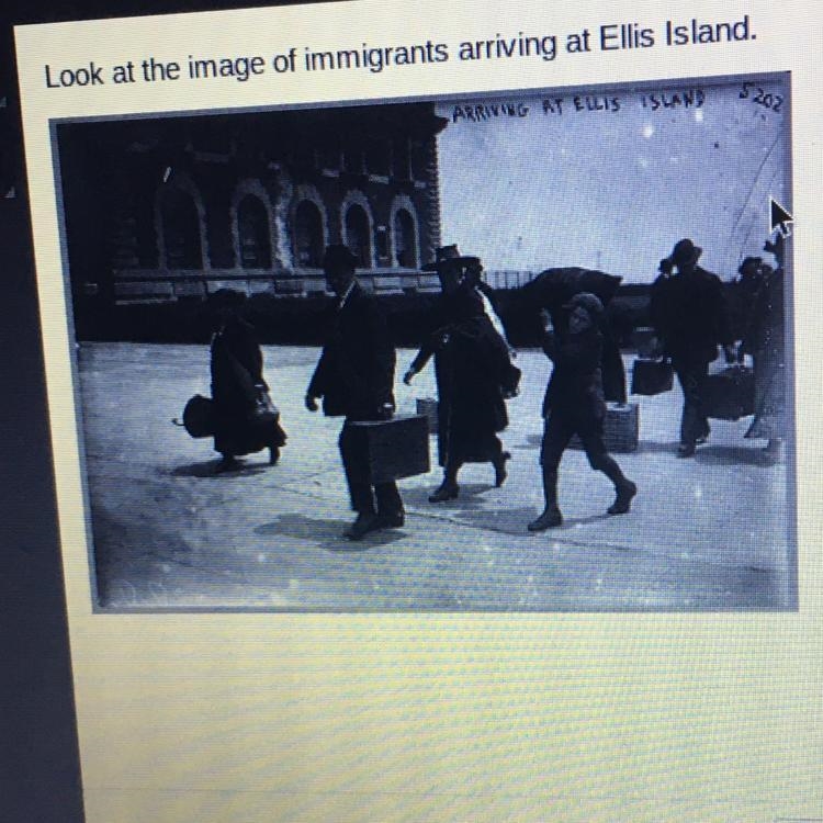 Look at the image of immigrants arriving at Ellis Island. Which item of clothing was-example-1