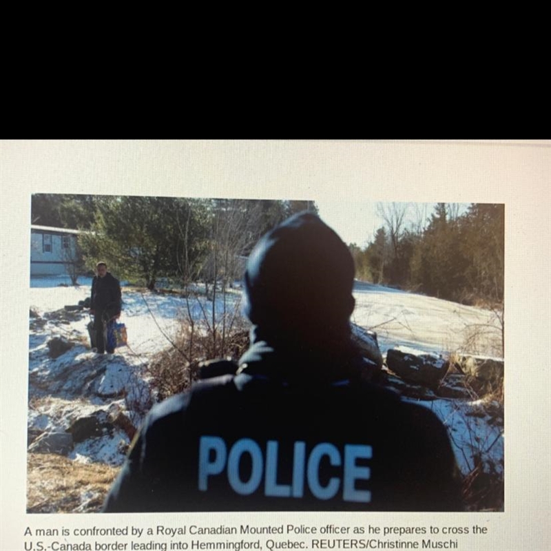 POLICE A man is confronted by a Royal Canadian Mounted Police officer as he prepares-example-1