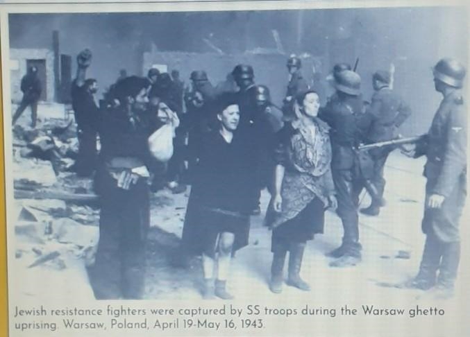 What can you infer about the Holocaust based on this photo and caption? What surprises-example-1