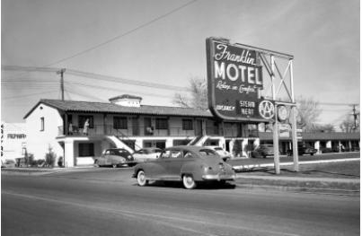 Using the picture provided, how did the automobile influence the hotel industry? A-example-1