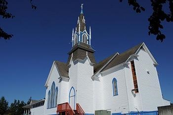 The photo shows a church in Poulsbo, Washington. The architecture of this church reflects-example-1