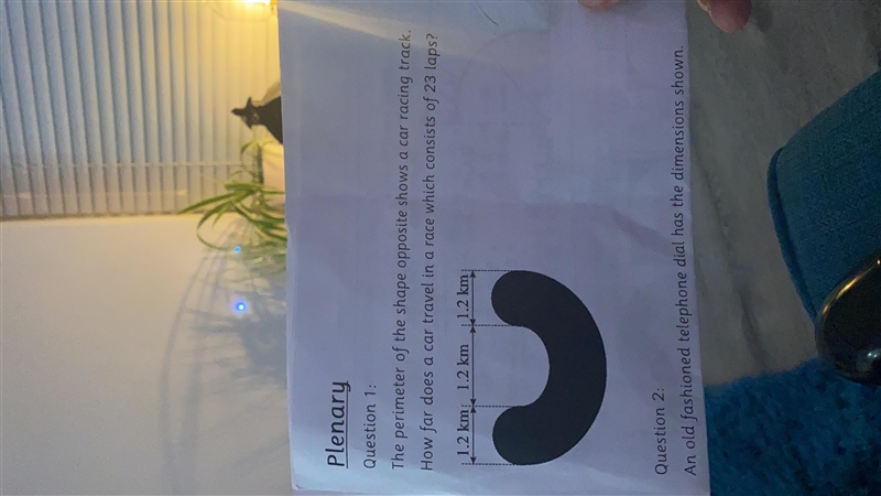 The perimeter of a shape shows a car racing track, how far does a car travel in a-example-1