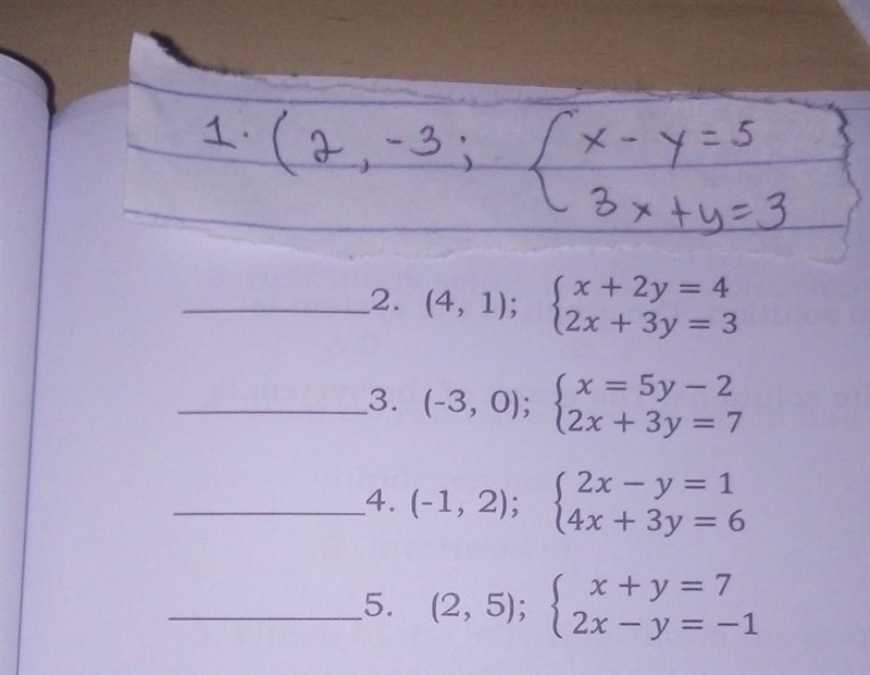 HAPPYface if the given ordered pair is a solution to the system and a SAD faceof not-example-1