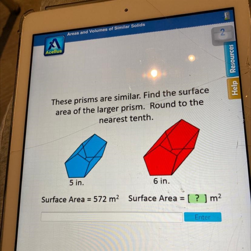 These prisms are similar. Find the surface area of the larger prism. Round to the-example-1