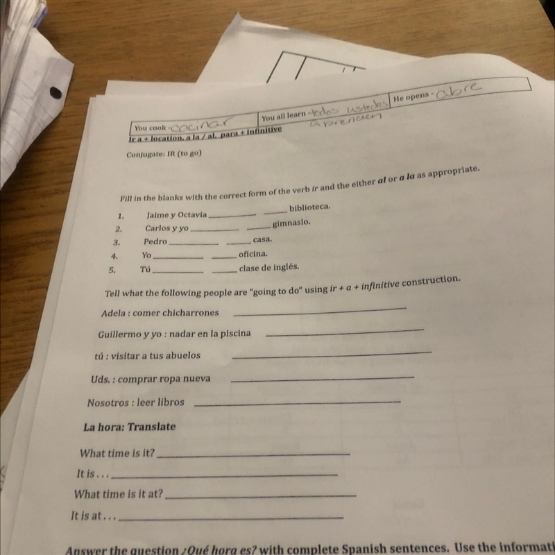 Fill in the blanks with the correct form of the verb ir and the either al or a la-example-1