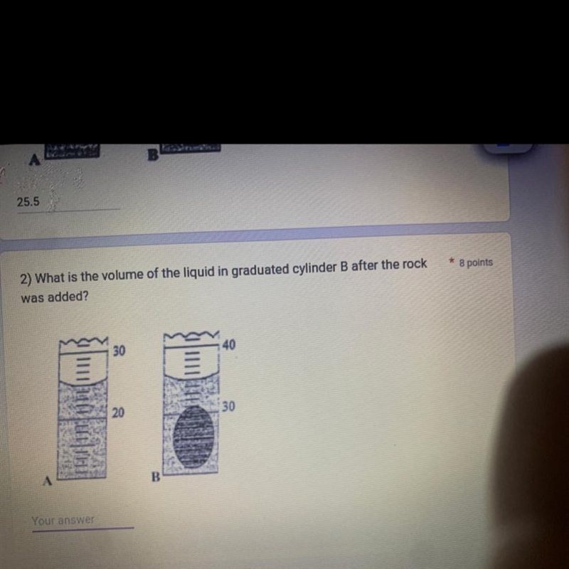 2) What is the volume of the liquid in graduated cylinder B after the rockwas added-example-1