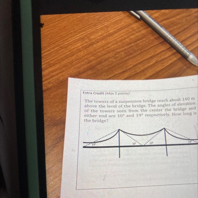 The towers of a suspension bridge reach about 140 mabove the level of the bridge. The-example-1