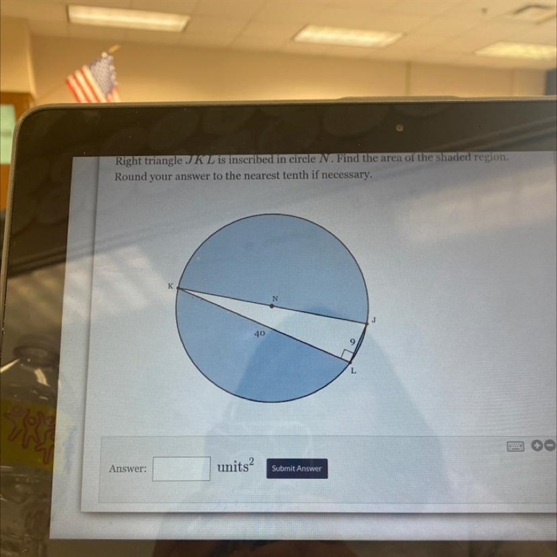Right triangle JKL is inscribed in circle N. Find the area of the shaded region. Round-example-1