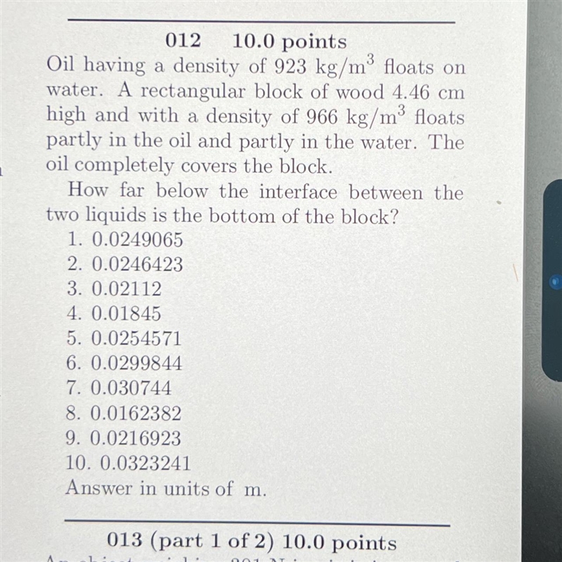 How far below the interface between the two liquids is the bottom of the block-example-1